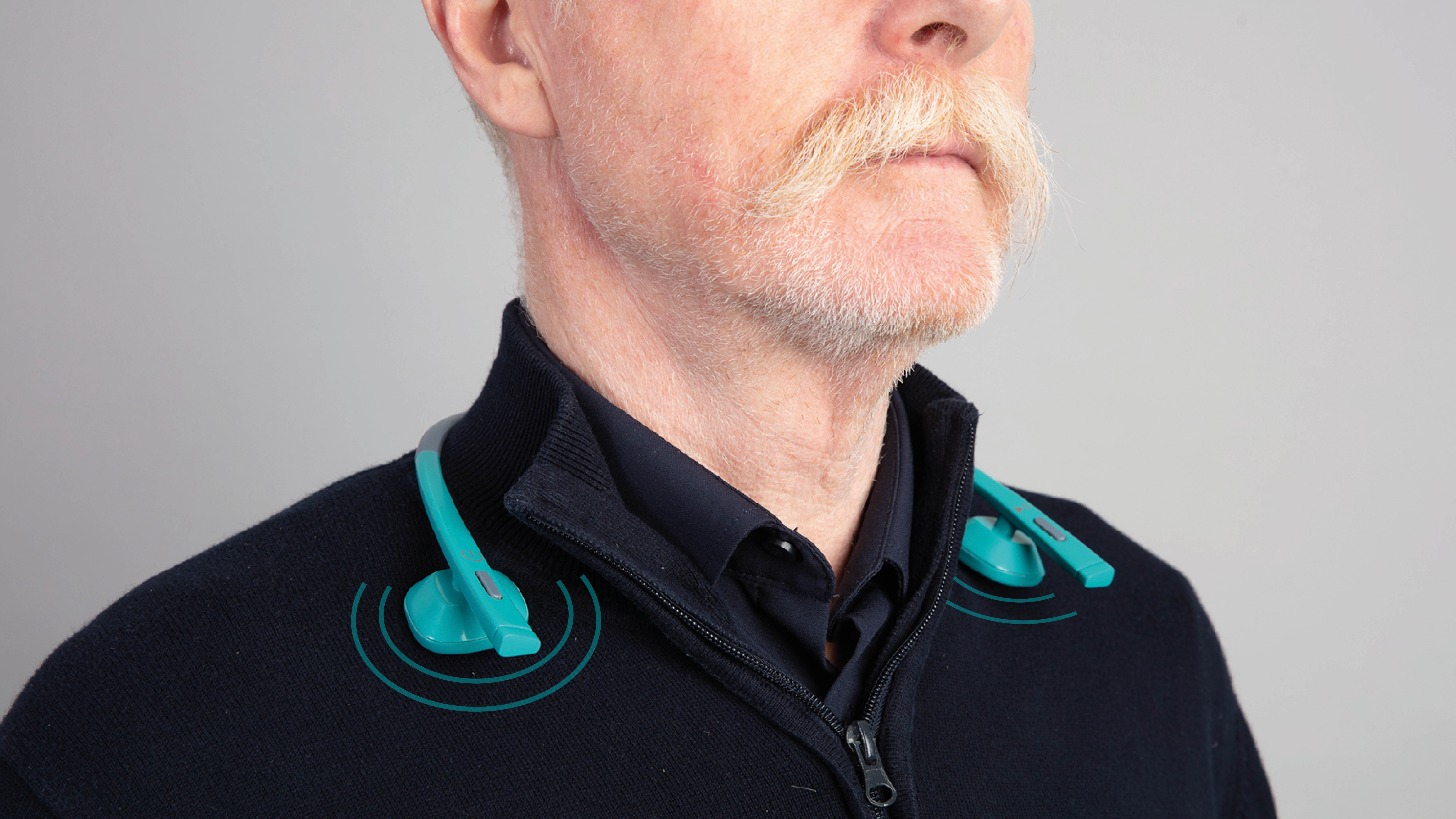 An image with a caption of: The neckband plays a noise through the collarbone that only you can hear.
