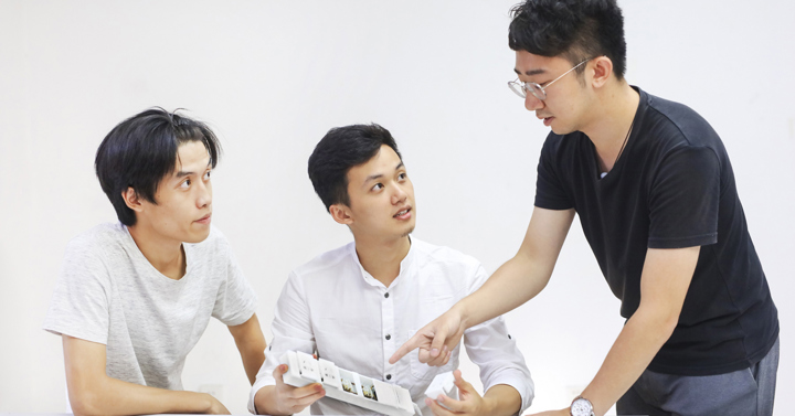 Image of China national winner team looking at their prototype
